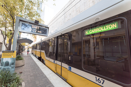 Yellow light rail train at station in downtown Dallasのeditorial素材