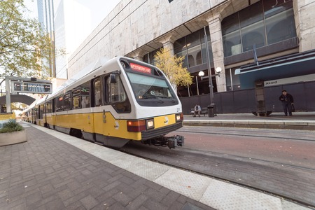 Coming light rail train at station in downtown Dallasのeditorial素材