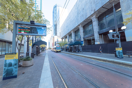Light rail train station with passenger waiting in downtown Dallのeditorial素材