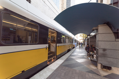 Yellow light rail train at station in downtown Dallasのeditorial素材