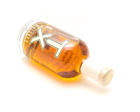 Lying bottle of TX Blended Whiskey isolated on white from Firestのeditorial素材