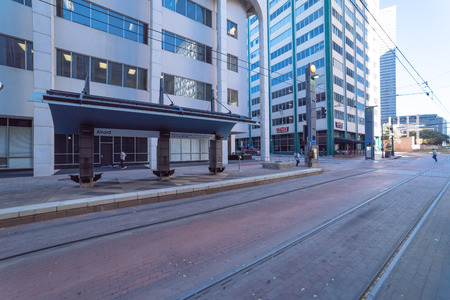 Light rail train station with passenger waiting in downtown Dallのeditorial素材