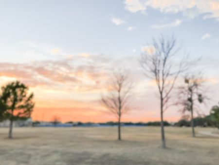 Blurry background dramatic sunset at city park with pathway in sの写真素材