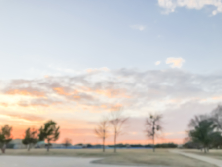 Blurry background dramatic sunset at city park with pathway in sの写真素材