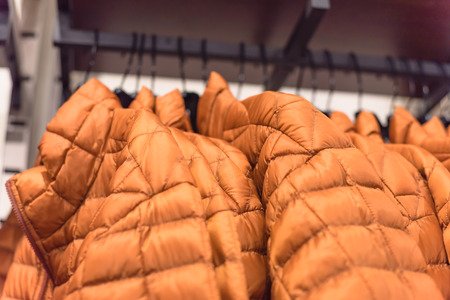 Row of women down jackets at American outdoor clothing storeの写真素材