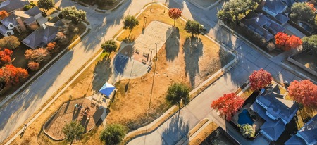 Panoramic top view residential playground with colorful fall leaの写真素材