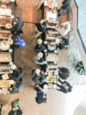Blurry background top view many people at catering lunch buffet meal in hotel eventの写真素材