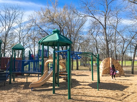 Outdoor playground with children playing wintertime in North Texas, Americaの写真素材