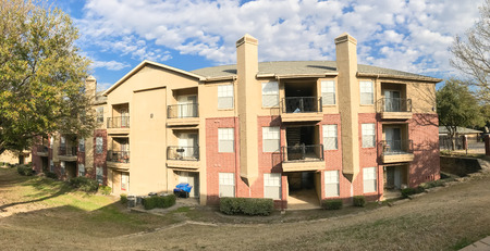 Panoramic view typical apartment complex with steep grassy backyard in Americaの写真素材