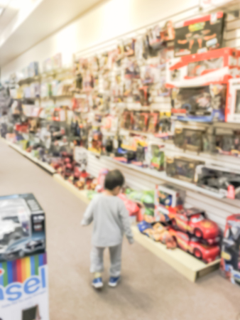 Blurry background toddler boy choosing toy at toys tore in USAの写真素材