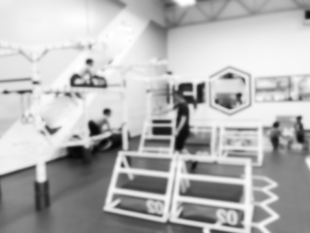 Blurry background coach and kids at children gym class in USAの写真素材