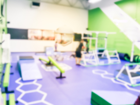 Blurry background coach and kids at children gym class in USA