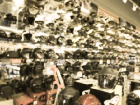 Filtered image blurry background variety of motorcycle helmet at retail store in USAの写真素材