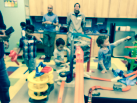 Filtered image blurry background children and parents playing indoor game together