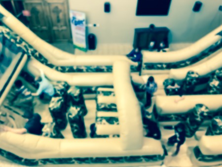 Vintage tone blurred motion top view huge indoor inflatable slide at game day in American churchの写真素材
