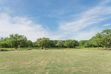 Beautiful park with grassy lawn, trees, decorative landscape rock. Nature area near Dallas, Texas, USAの写真素材