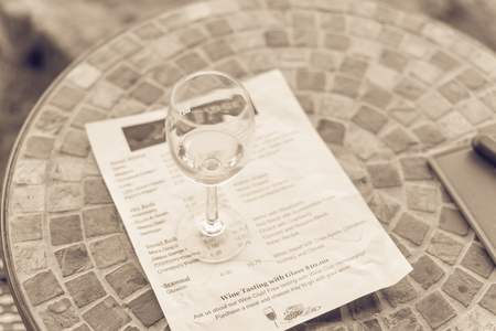 Vintage tone top view a glass of sweet white wine and tasting menu with price at local winery in North Texas, Americaの写真素材