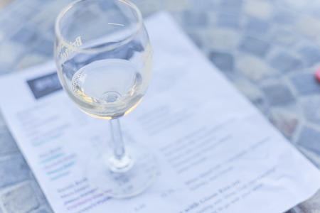 Close-up a glass of sweet white wine and tasting menu with price at local winery in North Texas, Americaの写真素材