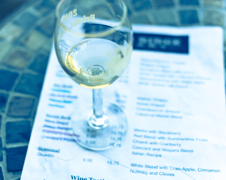Vintage tone top view a glass of sweet white wine and tasting menu with price at local winery in North Texas, Americaの写真素材