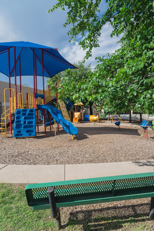 Bench and playground with colorful structure equipment near Dallas, Texasの写真素材