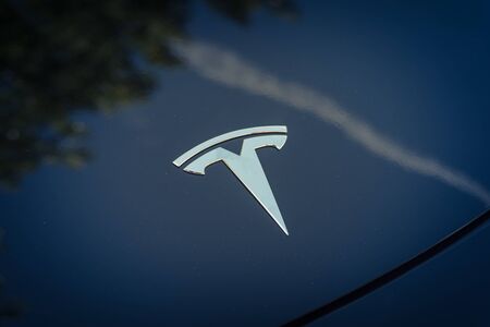 DALLAS, TX, US-APR 26, 2019: Shiny logo of Tesla on new model electric car. Close-up view of front Tesla badge on outdoor black car hoodのeditorial素材