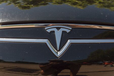 DALLAS, TX, US-APR 26, 2019: Shiny logo of Tesla on new model electric car. Close-up view of front Tesla badge on outdoor black car hoodのeditorial素材