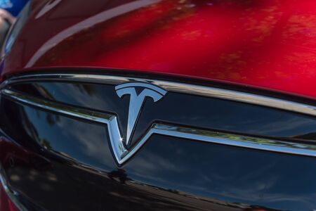 DALLAS, TX, US-APR 26, 2019: Shiny logo of Tesla on new model electric car. Close-up view of front Tesla badge on outdoor red car hoodのeditorial素材