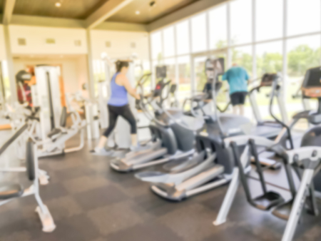 Blurry background lady in sportswear at open fitness center in new home community in USA