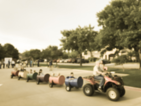 Filtered tone blurry background fun wagon train ride for kids and parents at school eventの写真素材