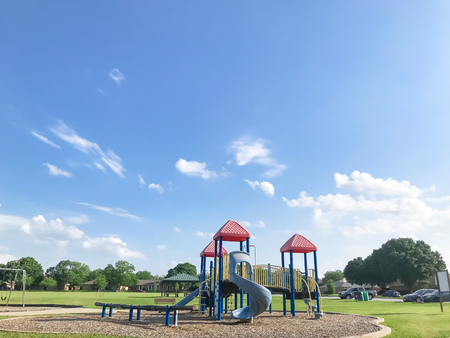 Public playground for kids at green park on sunny day in Texas, USA