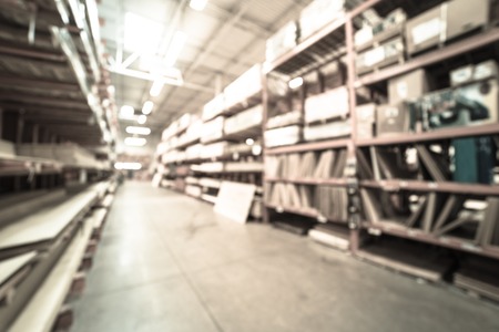 Filtered image blurry background lumber stacks on shelves at American hardware store