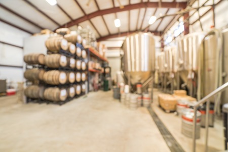 Blurry background stack of barrels in cellar at American brewery