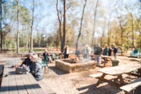 Blurry background  forest campfire and people hangout at wintertime in Texas, USA