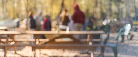 Panoramic view blurry  forest campfire and people hangout at wintertime in Texas, USA