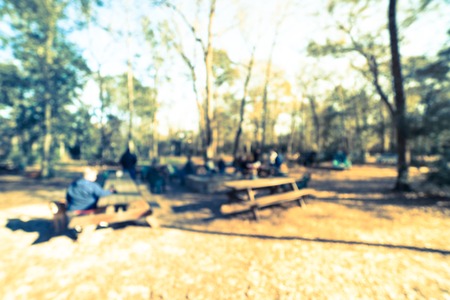 Filtered image blurry  forest campfire and people hangout at wintertime in Texas, USA