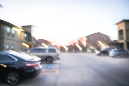 Blurry background busy uncovered parking lots at apartment complex in Americaの写真素材