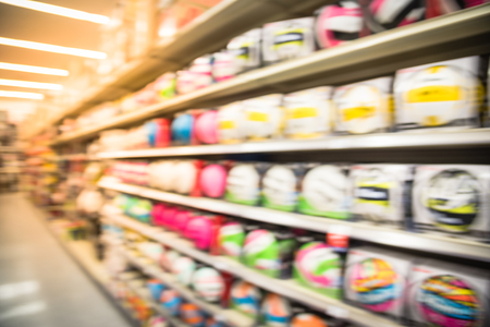 Blurry background aisle at sport store with variety of soccer, volleyballs and basketballsの写真素材