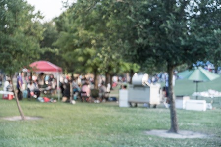 Filtered tone blurry background resident enjoy BBQ and camping at local park in USA