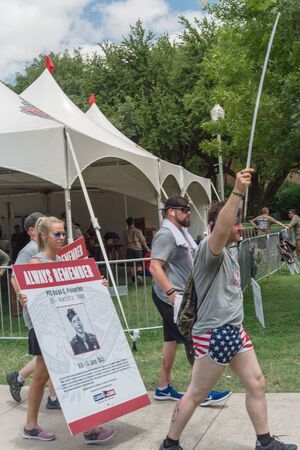 Crowded people carry photos placards of Fallen Heroes at Memorial Day paradeのeditorial素材