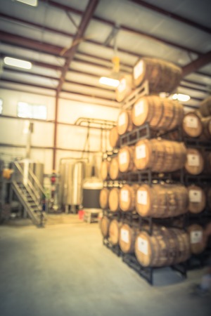 Blurry background metal tanks in microbrewery in Texas, USA