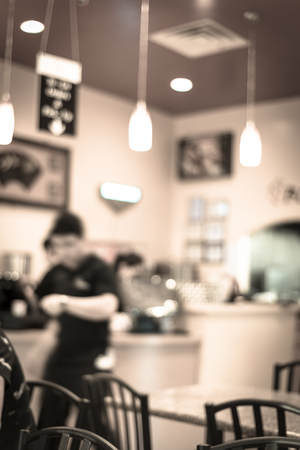 Filtered image blurry background waiters serving food at compact Vietnamese noodle restaurantの写真素材