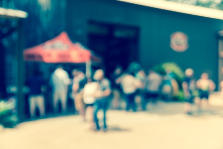 Blurred image group of people standing, hanging out at craft brewery company in Conroe, Texas, US. Draft beer serving in the tent. Friends Outdoor Nature Picnic Chilling Out Unity Concept, sunny day.の写真素材