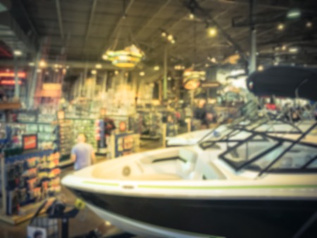 Blurred abstract variety of boat and ATV vehicles at showroom large outdoor store in Texas, America. Boat buying and servicing conceptの写真素材
