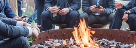 Panoramic view businesspeople hangout near patio fire pit at wintertime in Chicago, America