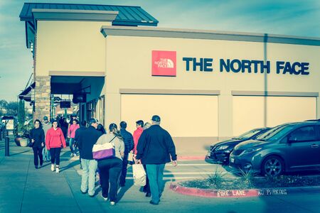 Filtered image customers walking by The North Face store at outlet shopping in Texas, Americaのeditorial素材