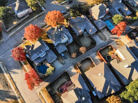 Aerial view typical house with light snow covered roof in cold fall morning