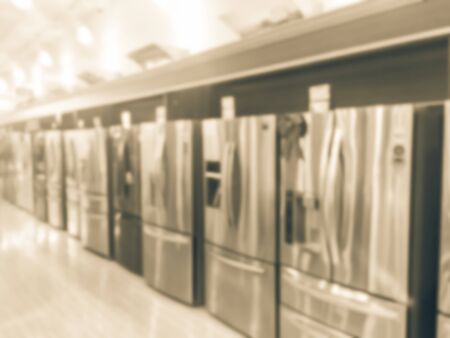 Filtered image blurry background rows of brand new French door refrigerators with ice makersの写真素材