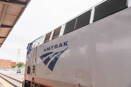 FORT WORTH, TX, US-MAY 10, 2019: Close-up logo of Amtrak near train door entrance. The National...