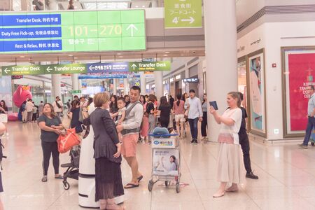 SOUTH KOREA-JULY 14, 2019: Travelers taking photo with AIRSTAR Passenger Aiding Robot at Incheon International Airport. Second-generation robot can help airline passengers navigate departures hallのeditorial素材