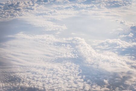 Beautiful and unusual Altocumulus or Cirrocumulus cloud formation seen from airplane window at...